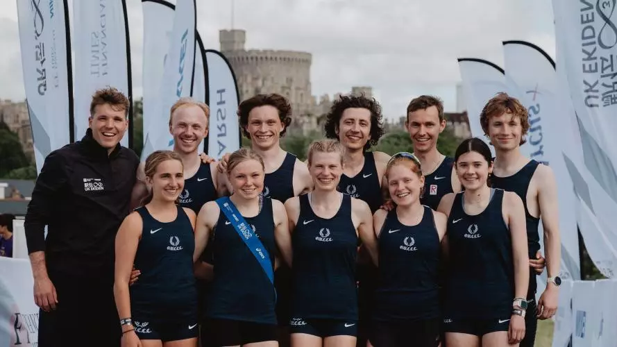 Photo of winning ekiden team from Oxford in front of Windsor castle with coach Matt Seddon